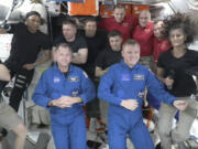 In this image made from a NASA livestream, the two astronauts stuck at the International Space Station since June 2024, Butch Wilmore, far left, and Suni Williams, far right, welcome two new residents who flew up on SpaceX, NASA&rsquo;s Nick Hague, front left in blue, and the Russian Space Agency&rsquo;s Alexander Gorbunov, front right in blue, Sunday, Sept. 29, 2024. Behind them, from left in black, are NASA&rsquo;s Jeanette Epps, Russia&rsquo;s Alexander Grebenkin, NASA&rsquo;s Mike Barratt and NASA&rsquo;s Matthew Dominick. From left, wearing red, are Russia&rsquo;s Ivan Vagner, NASA&rsquo;s Don Pettit and Russia&rsquo;s Alexei Ovchinin.