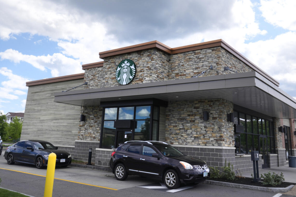 Cars drive through the pick-up window at a Starbucks store on May 29, 2024, in Salem, N.H.