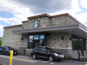 Cars drive through the pick-up window at a Starbucks store on May 29, 2024, in Salem, N.H.