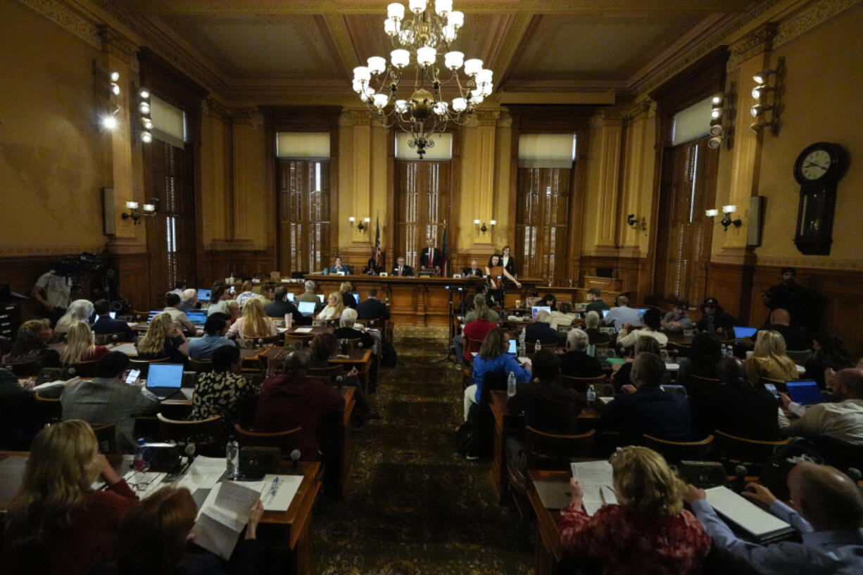 Georgia&#039;s State Election Board members discuss proposals to a full room for election rule changes at the state capitol, Friday, Sept. 20, 2024, in Atlanta.