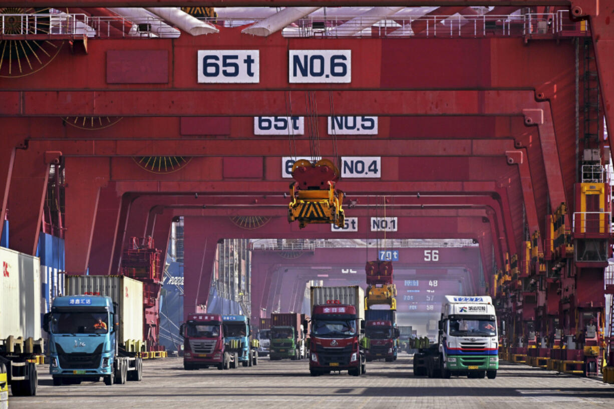 FILE - In this photo released by Xinhua News Agency, containers are unloaded from a cargo ship at Qingdao Port, east China&rsquo;s Shandong Province on Feb. 11, 2024.