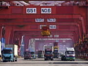 FILE - In this photo released by Xinhua News Agency, containers are unloaded from a cargo ship at Qingdao Port, east China&rsquo;s Shandong Province on Feb. 11, 2024.