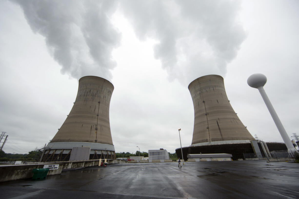 FILE - This May 22, 2017 file photo, shows cooling towers at the Three Mile Island nuclear power plant in Middletown, Pa.