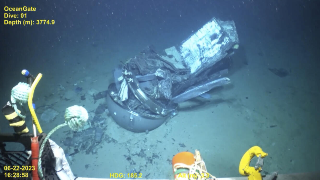 This June 2023 United States Coast Guard still frame from video provided by Pelagic Research Services, shows remains of the Titan submersible, center, on the floor of the Atlantic Ocean. (U.S.