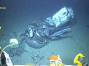 This June 2023 United States Coast Guard still frame from video provided by Pelagic Research Services, shows remains of the Titan submersible, center, on the floor of the Atlantic Ocean. (U.S.