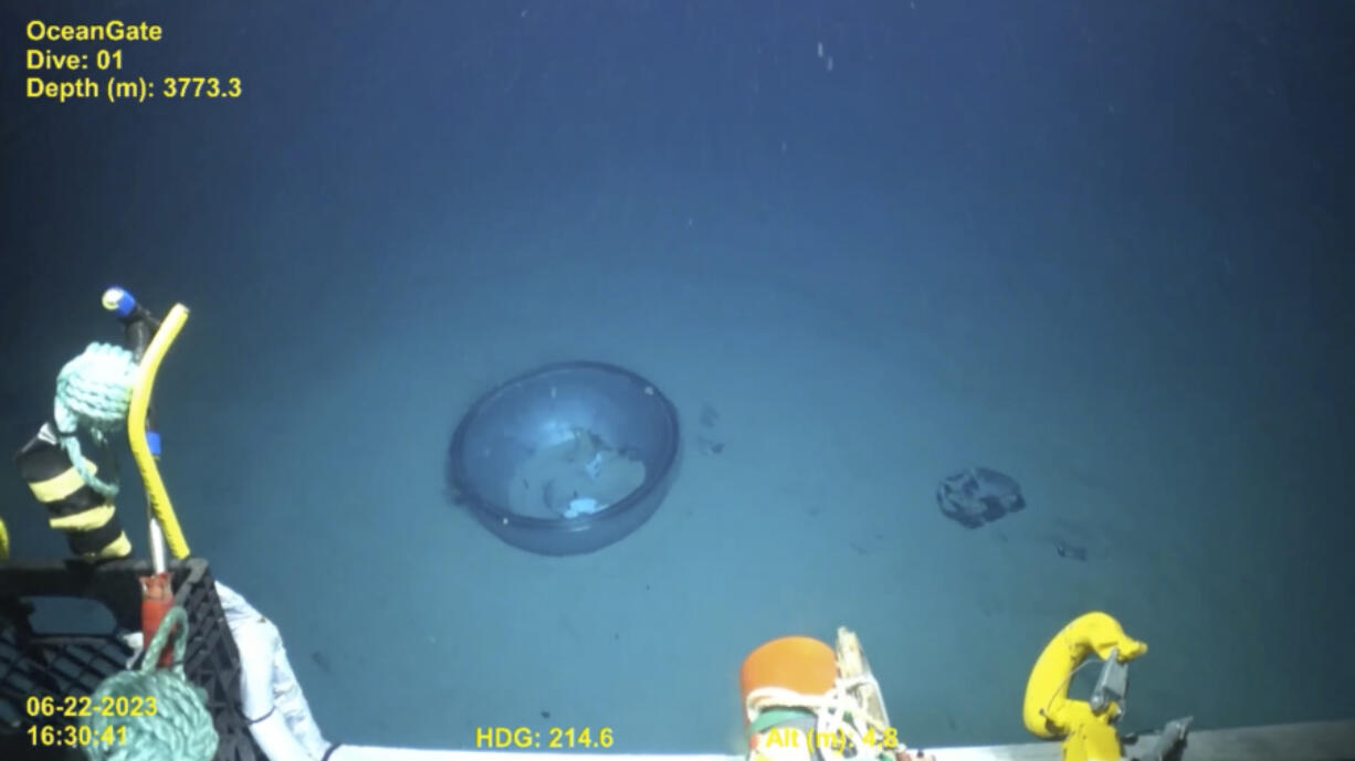 This June 2023 United States Coast Guard still frame from video provided by Pelagic Research Services, shows remains of the Titan submersible, center, on the floor of the Atlantic Ocean. (U.S.