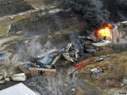 FILE - In this photo taken with a drone, portions of a Norfolk Southern freight train that derailed the previous night in East Palestine, Ohio, remain on fire at mid-day, Feb. 4, 2023. (AP Photo/Gene J.