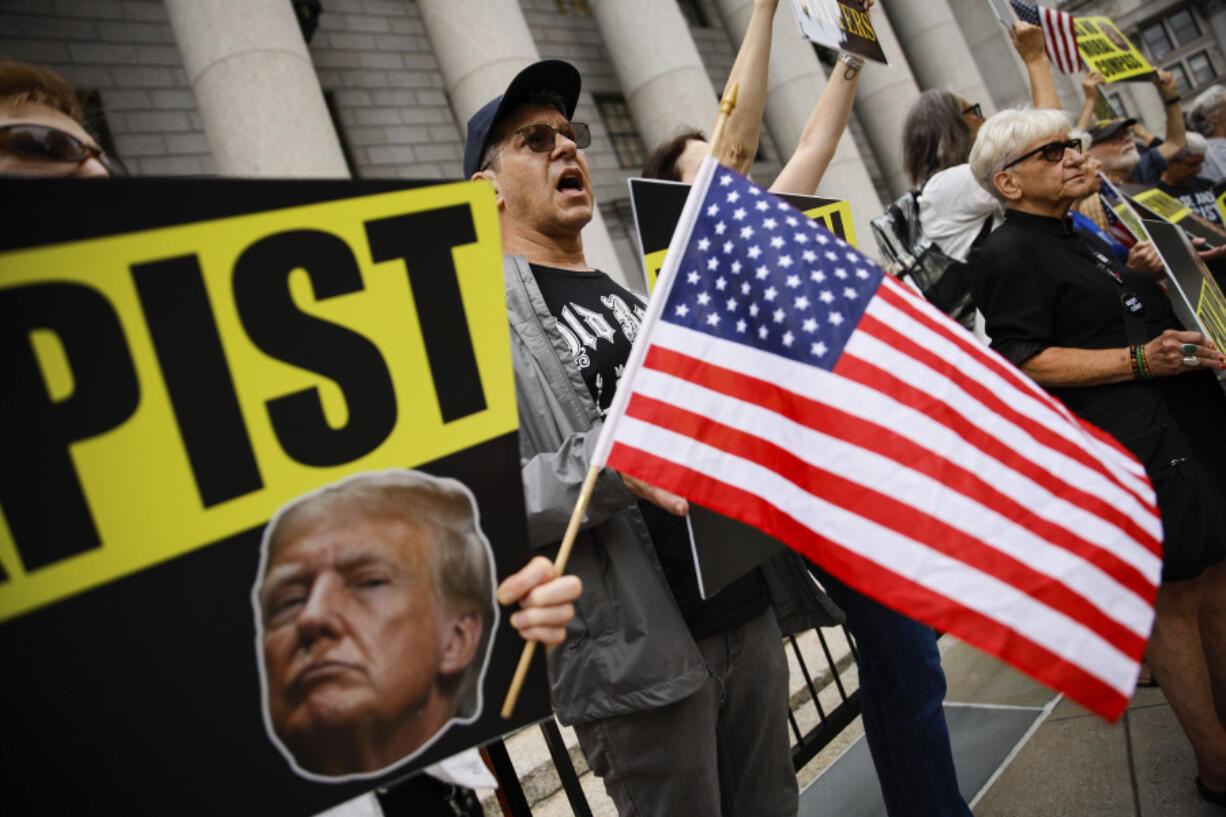 People protest against former President Donald Trump before his arrival to the New York Federal Court, Friday, Sept. 6, 2024, in New York.