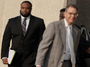 Former Memphis police officer Demetrius Haley, left, leaves the federal courthouse after the first day of jury selection of the trial in the Tyre Nichols case Monday, Sept. 9, 2024, in Memphis, Tenn.