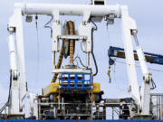 Workers on the vessel Nautilus that helped bury the subsea cables that run along the ocean floor to connect the wave energy test site to facilities on land near Newport, Ore., Friday, Aug. 23, 2024.