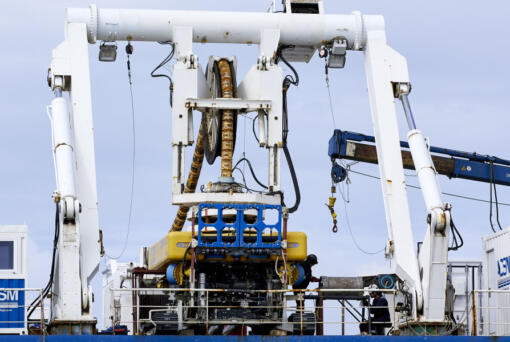 Workers on the vessel Nautilus that helped bury the subsea cables that run along the ocean floor to connect the wave energy test site to facilities on land near Newport, Ore., Friday, Aug. 23, 2024.