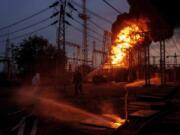 Rescue workers extinguish a fire of burning electrical substation hit by a Russian bombing in Dnipropetrovsk region, Ukraine, Monday, Sept. 2, 2024.