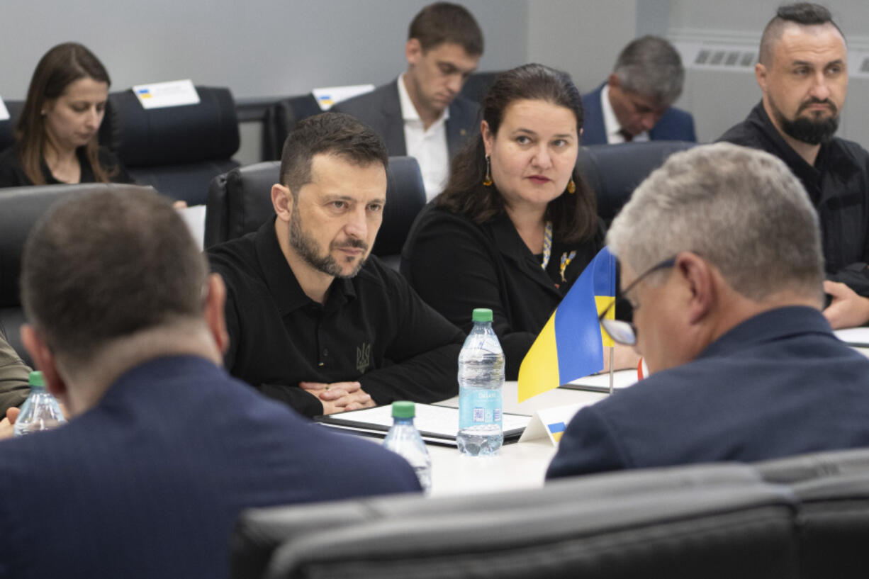 In this photo provided by the U.S. Army, Ukrainian President Volodymyr Zelenskyy, center, listens while visiting the Scranton Army Ammunition Plant in Scranton, Pa., Sunday, Sept. 22, 2024. (Sgt. 1st Class Curt Loter/U.S.