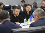 In this photo provided by the U.S. Army, Ukrainian President Volodymyr Zelenskyy, center, listens while visiting the Scranton Army Ammunition Plant in Scranton, Pa., Sunday, Sept. 22, 2024. (Sgt. 1st Class Curt Loter/U.S.