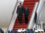 FILE - Venezuela&#039;s President Nicolas Maduro, left, and first lady Cilia Flores arrive at Beijing Capital International Airport in Beijing, China, Sept. 1, 2015.