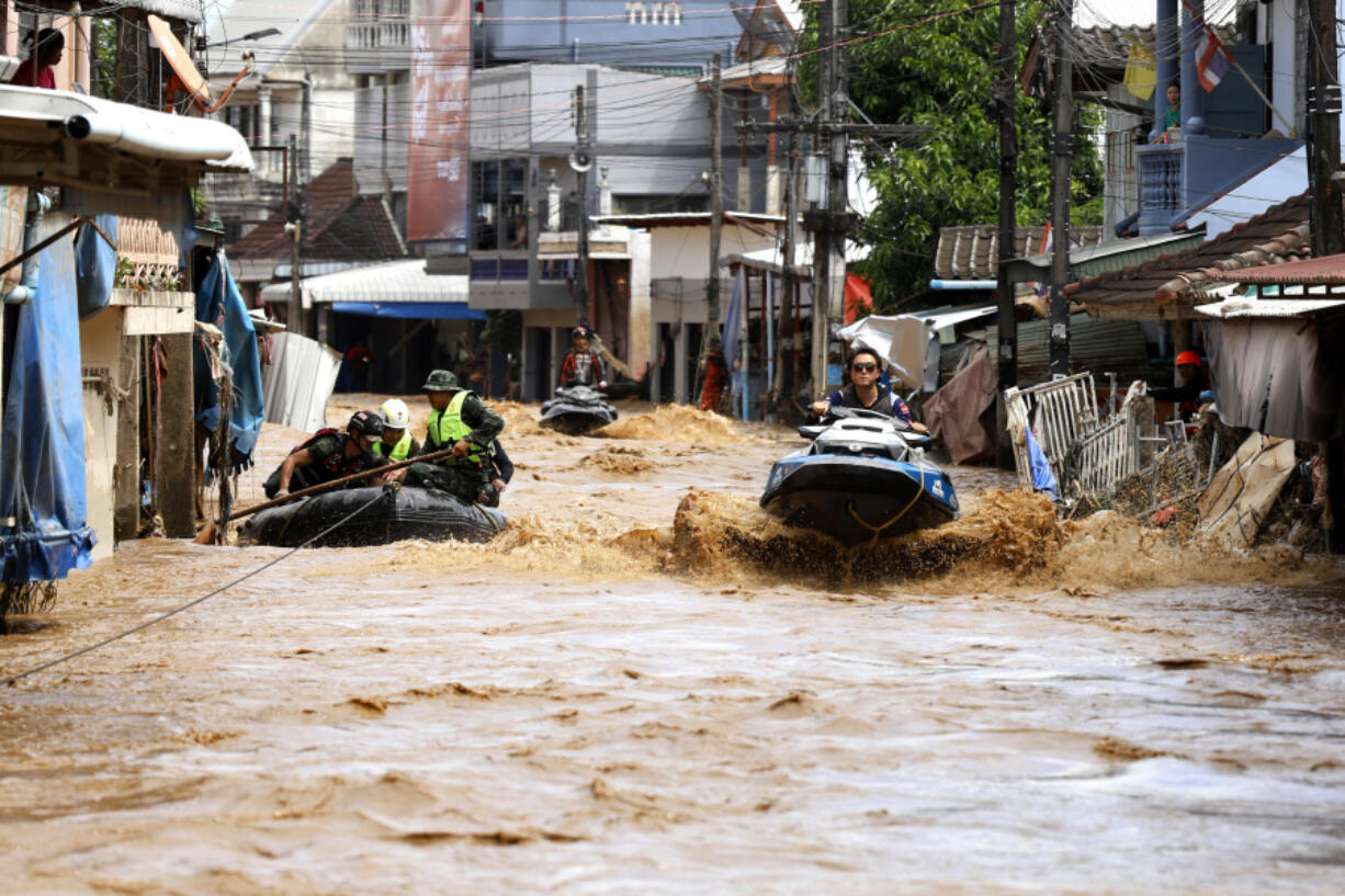 A rescue worker uses jet skis to search for victims in flooded areas in Chiang Rai Province, Thailand, Friday, Sept. 13, 2024.