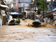 A rescue worker uses jet skis to search for victims in flooded areas in Chiang Rai Province, Thailand, Friday, Sept. 13, 2024.