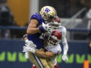 Washington wide receiver Leon Neal Jr., left, is tackleb y Washington State linebacker Kyle Thornton during the second half of an NCAA football game on Saturday, Sept. 14, 2024, in Seattle. Washington State won 24-19.