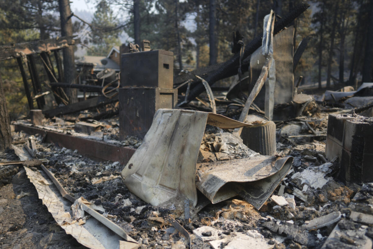 A fire-ravaged property is seen after the Bridge Fire swept through, Thursday, Sept. 12, 2024, in Wrightwood, Calif.