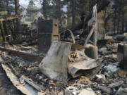 A fire-ravaged property is seen after the Bridge Fire swept through, Thursday, Sept. 12, 2024, in Wrightwood, Calif.