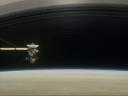 This April 2017 image from the short film &ldquo;Cassini&rsquo;s Grand Finale&rdquo; shows the space probe diving between Saturn and its innermost ring. Sunday night will offer the best Saturn viewing for Earth-bound observers this year.