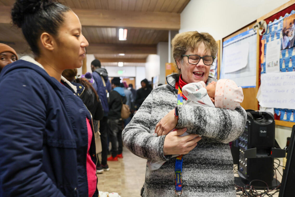 Jan Bolerjack, right, holds baby Olya with her mother Lori looking on Thursday afternoon at the Riverton Park Methodist Church in Tukwila Washington on Jan. 11, 2024.