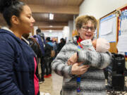 Jan Bolerjack, right, holds baby Olya with her mother Lori looking on Thursday afternoon at the Riverton Park Methodist Church in Tukwila Washington on Jan. 11, 2024.