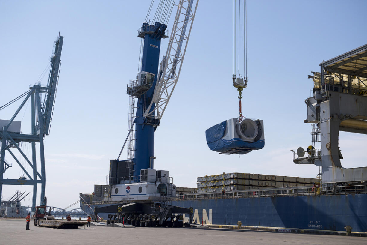 Crews unload a nacelle, the piece where the blades and turbine meet, from a ship at the Port of Vancouver in 2020. The port recently secured a $22.5 million federal grant to buy new electric cranes, which are used to move wind turbines, and make other &ldquo;green&rdquo; upgrades.