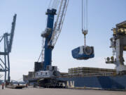 Crews unload a nacelle, the piece where the blades and turbine meet, from a ship at the Port of Vancouver in 2020. The port recently secured a $22.5 million federal grant to buy new electric cranes, which are used to move wind turbines, and make other &ldquo;green&rdquo; upgrades.