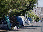 Tents line the side of the road along West 11th Street in downtown Vancouver in June. Council for the Homeless data shows the number of people experiencing homelessness in Clark County decreased for the first time in at least five years.