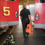 Robb Milano, Emergency Medical Services Division Chief, walks with an emergency medical kit. Proposed budget cuts would eliminate three positions in the Vancouver Fire Department and bring three captains back to line staffing. (Amanda Cowan/The Columbian)
