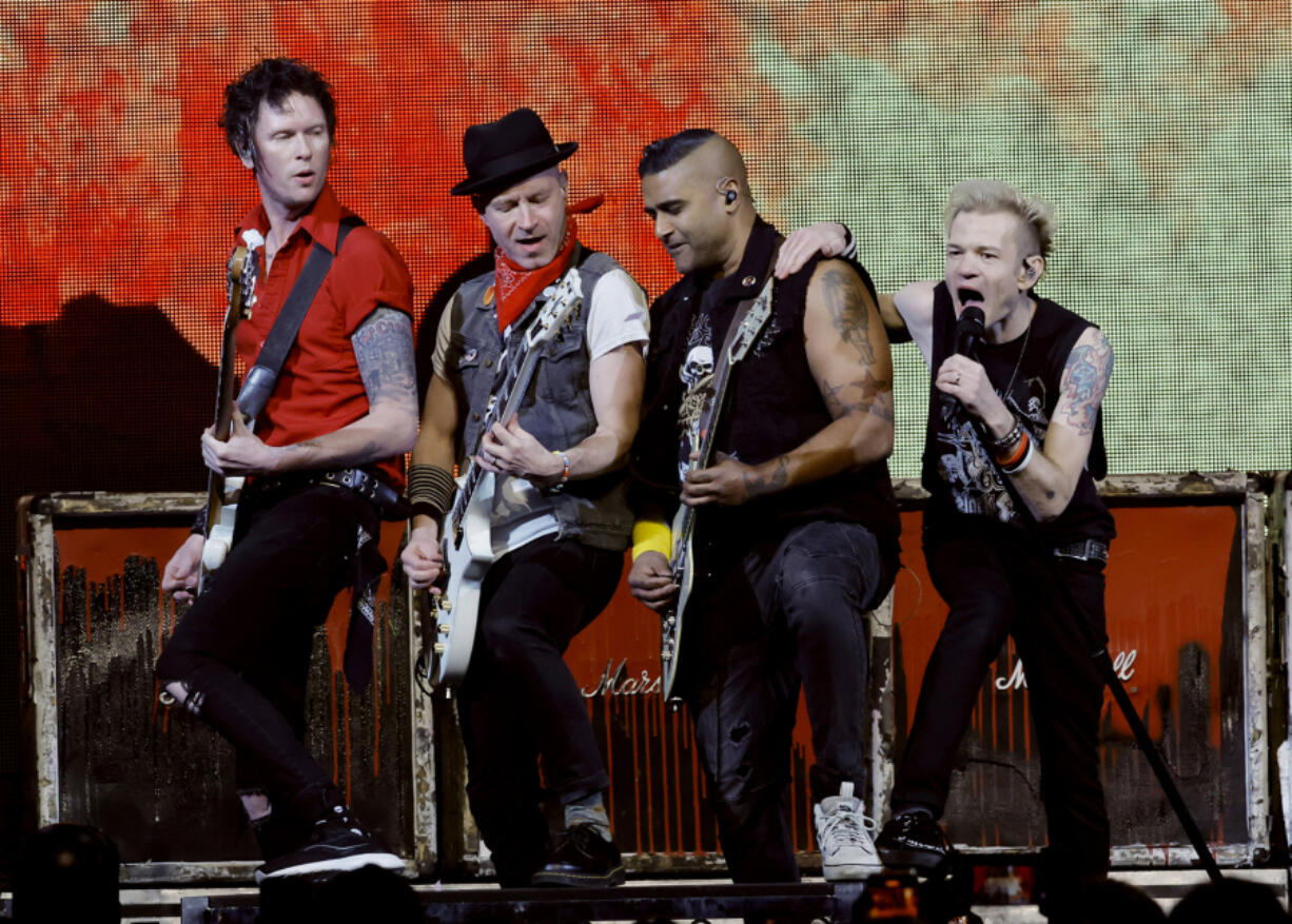 From left, Jason McCaslin, Tom Thacker, Dave Baksh and Deryck Whibley of Sum 41 perform Jan. 13 at the 2024 iHeartRadio ALTer EGO Presented by Capital One at the Honda Center in Anaheim, Calif.