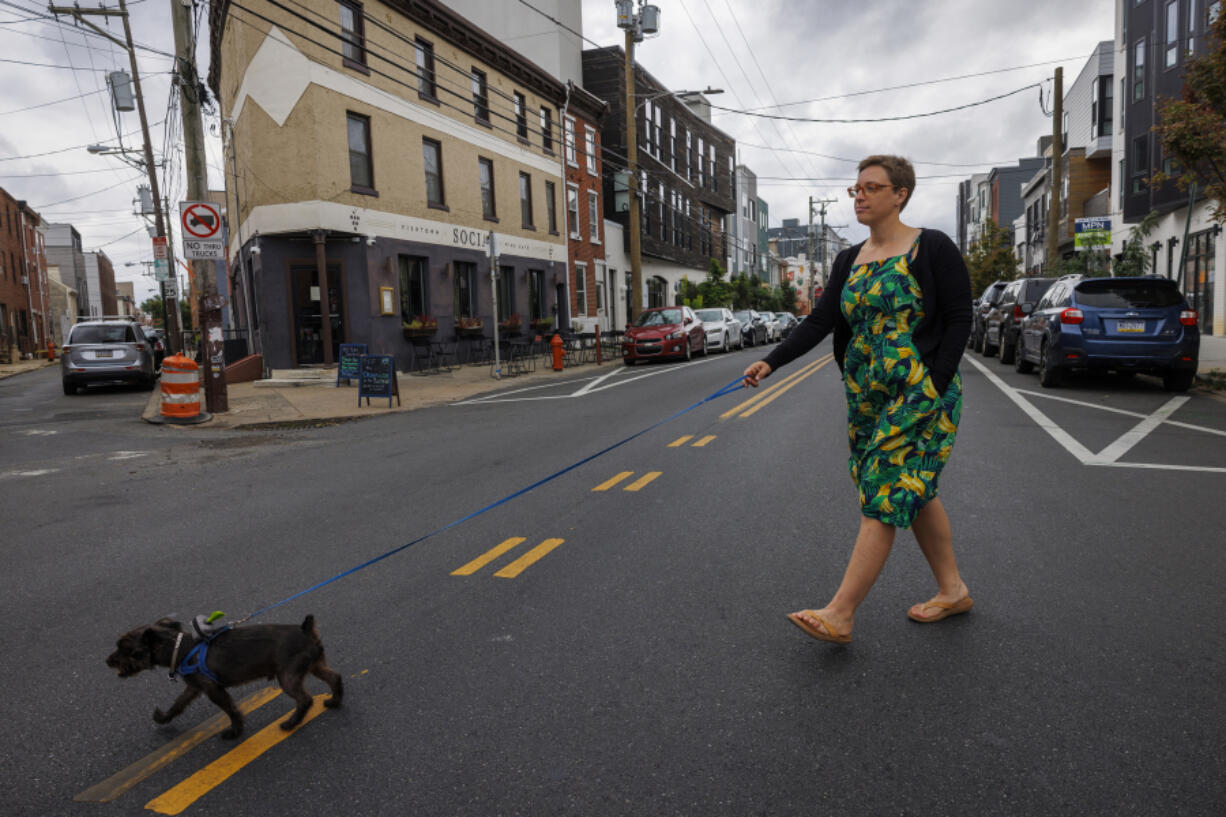 Amber Wilkie walks her 8-year-old Yorkie-Schnauzer mix, Duncan, on Sept. 17 near Fishtown Social Wine Cafe in Philadelphia. She and Duncan often run errands together during their walks. (Alejandro A.