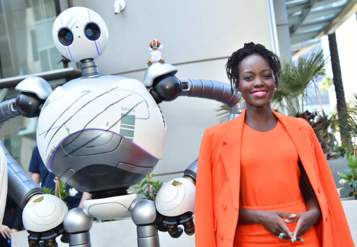 Lupita Nyong&rsquo;o poses with Roz the wild robot July 27 during San Diego Comic-Con International in San Diego.