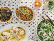 This image released by Celadon Books shows a table spread featuring a red rice dish, top center, from the cookbook &ldquo;Does This Taste Funny: Recipes Our Family Loves&rdquo; by Stephen Colbert and Evie McGee Colbert.