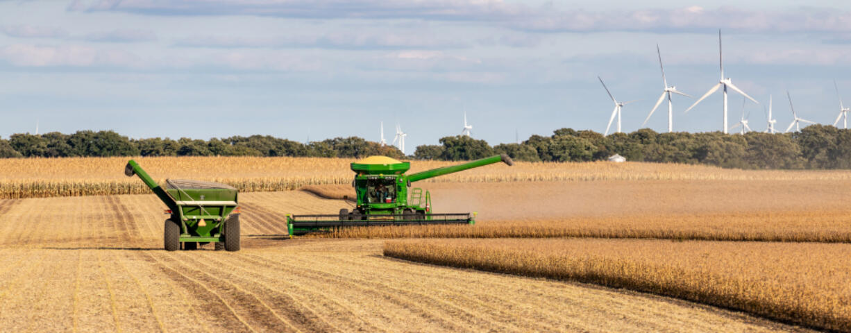 A combine harvester collects soybeans. China, a potential target in a trade war, is the largest buyer of U.S. soybeans.