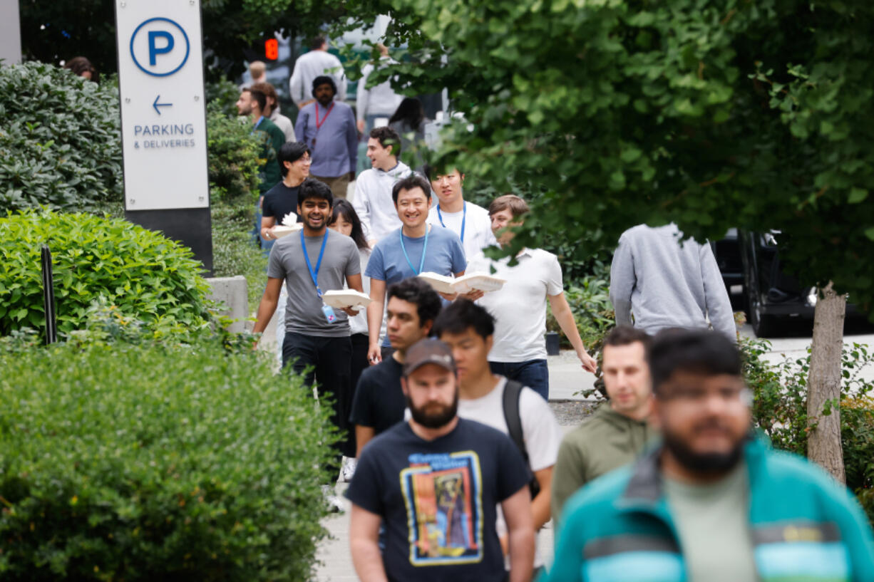 Sidewalks fill with pedestrians during lunch hour in South Lake Union in Seattle on Aug. 21, 2024. Various return-to-office mandates by Amazon and others last year are bringing more people into the area.