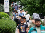 Sidewalks fill with pedestrians during lunch hour in South Lake Union in Seattle on Aug. 21, 2024. Various return-to-office mandates by Amazon and others last year are bringing more people into the area.