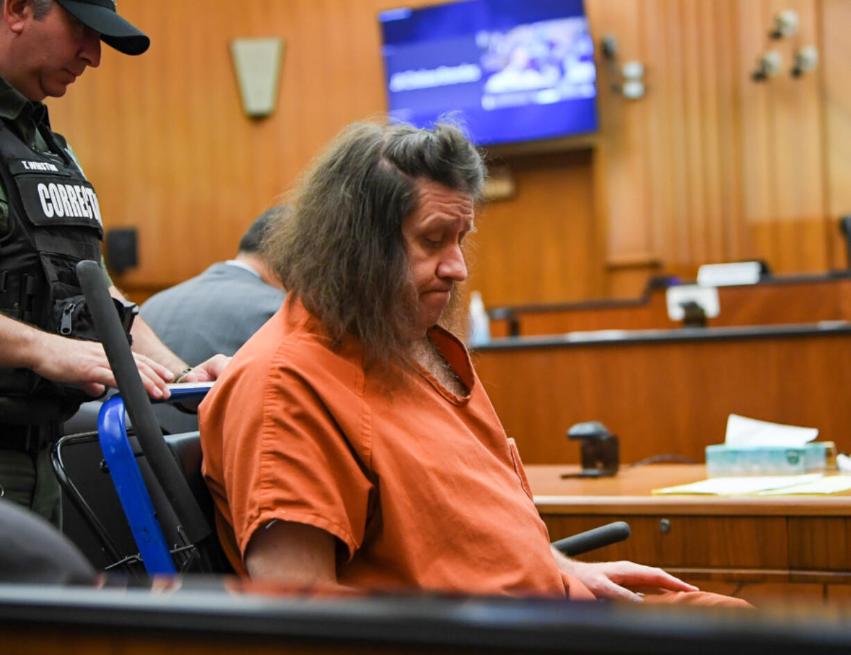 A corrections officer pushes Kenneth Jay Moore, 53, into a courtroom for a hearing Aug. 23 in Clark County Superior Court. Moore was resentenced Wednesday to 33 years in prison for the 2017 killing of his mother at their Vancouver home. He was originally sentenced to 34 years in prison, but the Washington Court of Appeals found factors that a judge considered when he ordered the sentence were not properly proven to the jury that convicted him.