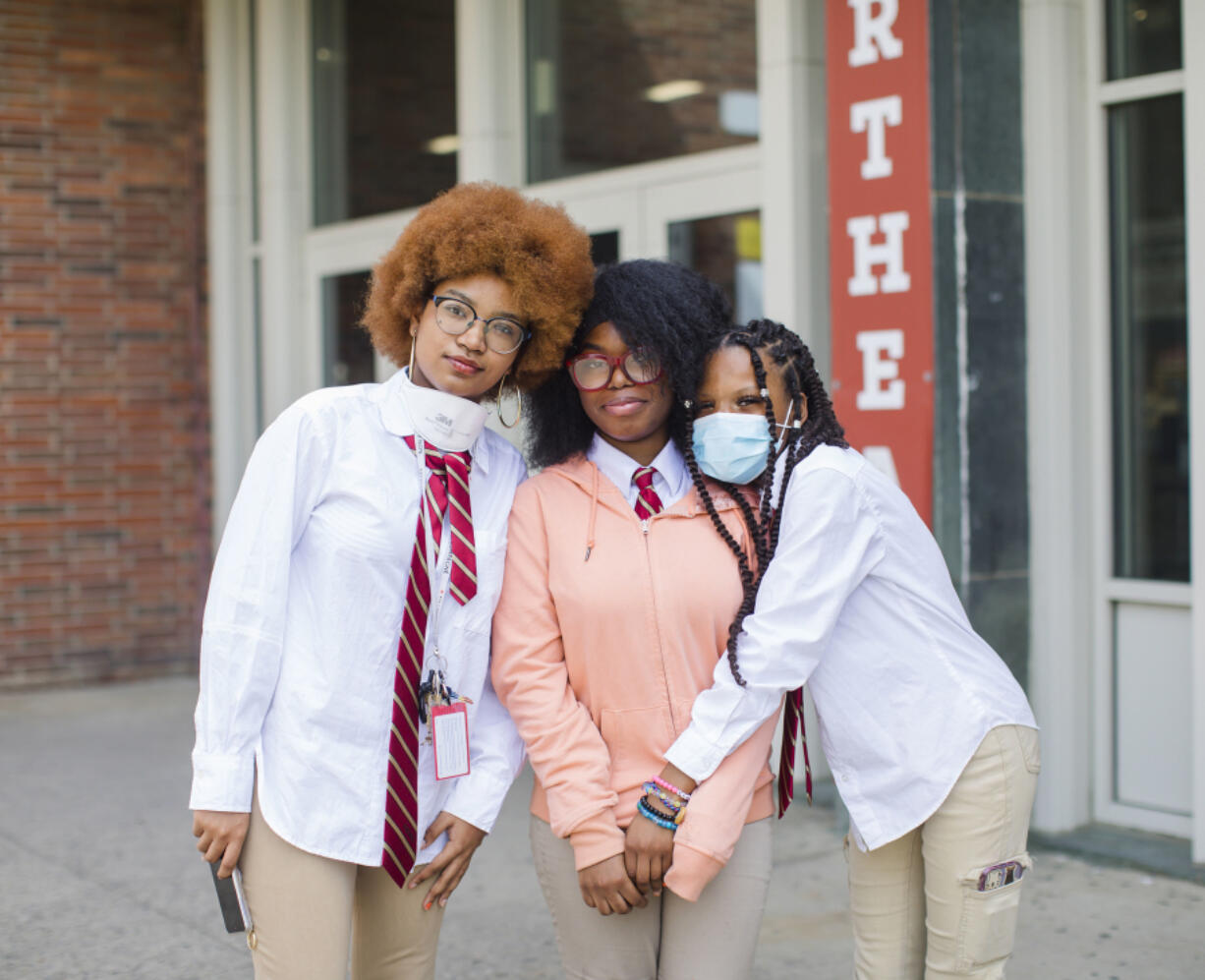 Northeast High School students, from left, Sylvie Deslouches, Harmony-Spirit Morrison, and Loviena Louiger are photographed during Afro Day outside their school on April 14, 2023. Students at Northeast hosted Afro Day to celebrate natural hair and all it means, personally and culturally.