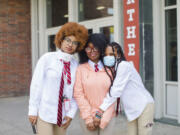 Northeast High School students, from left, Sylvie Deslouches, Harmony-Spirit Morrison, and Loviena Louiger are photographed during Afro Day outside their school on April 14, 2023. Students at Northeast hosted Afro Day to celebrate natural hair and all it means, personally and culturally.