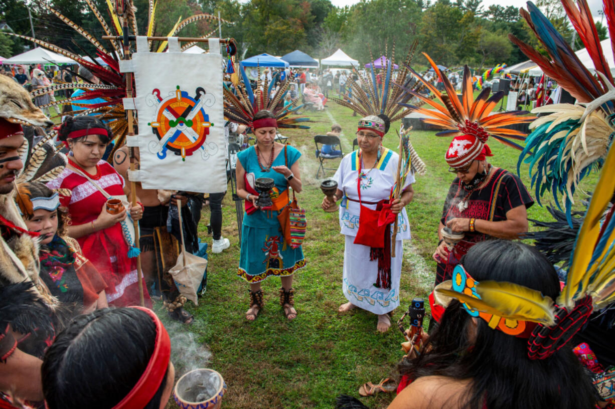 Members of Cetiliztli Nauhcampa stand in a circle together before taking part in a Four Directions Ceremony at the first Annual Indigenous Peoples&#039; Day Ceremonial Celebration in Newton, Massachusetts on Oct. 11, 2021.