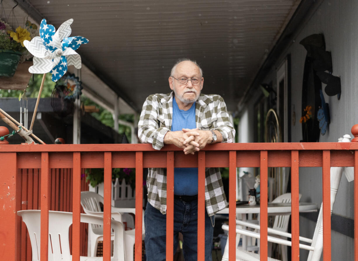 Lewis Record stands on his porch at his mobile home in Fruit Valley. Record is against adding more housing to Fruit Valley until the city does something to improve the neighborhood’s air quality.