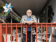 Lewis Record stands on his porch at his mobile home in Fruit Valley. Record is against adding more housing to Fruit Valley until the city does something to improve the neighborhood’s air quality.