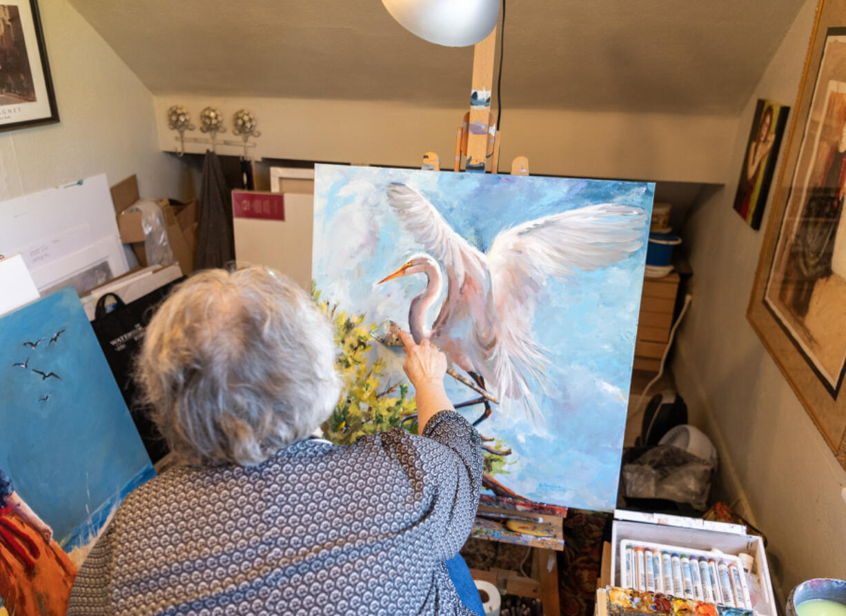 Vancouver artist Bev Jozwiak works on an acrylic painting Friday at her home.