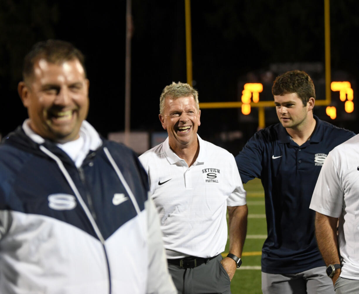 Skyview head football coach Steve Kizer, center, laughs on Sept. 13, 2024, after Skyview&Ccedil;&fnof;&Ugrave;s win against Graham-Kapowsin at Kiggins Bowl.