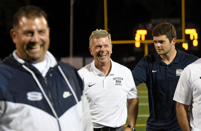 Skyview head football coach Steve Kizer, center, laughs on Sept. 13, 2024, after Skyview&Ccedil;&fnof;&Ugrave;s win against Graham-Kapowsin at Kiggins Bowl.