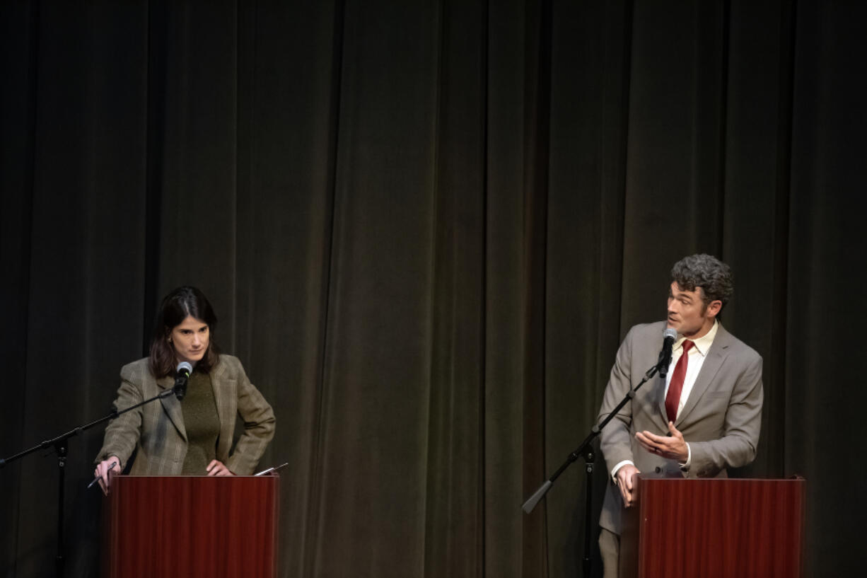 U.S. Rep. Marie Gluesenkamp Perez, left, listens as challenger Joe Kent speaks during a contentious debate at Lower Columbia College in Longview on Wednesday evening.