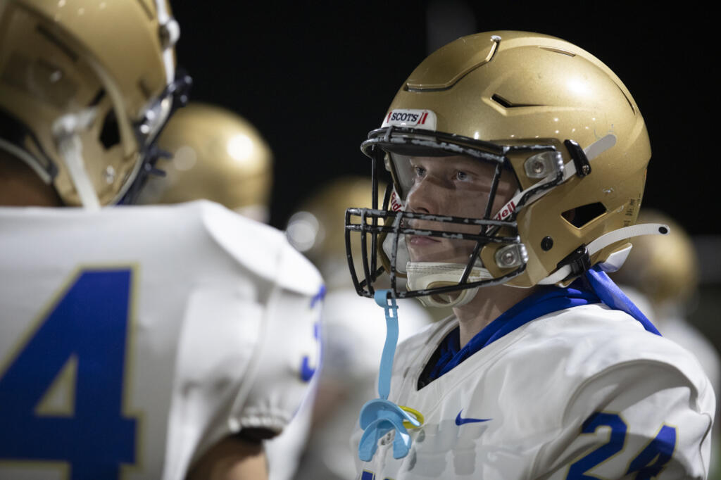 Kelso's Trevin Roller (24) talks with a teammate on the sidelines on Friday, Oct. 4, during Evergreen’s 42-35 win against Kelso at McKenzie Stadium.