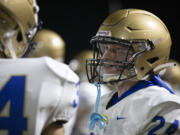 Kelso's Trevin Roller (24) talks with a teammate on the sidelines on Friday, Oct. 4, during Evergreen’s 42-35 win against Kelso at McKenzie Stadium.